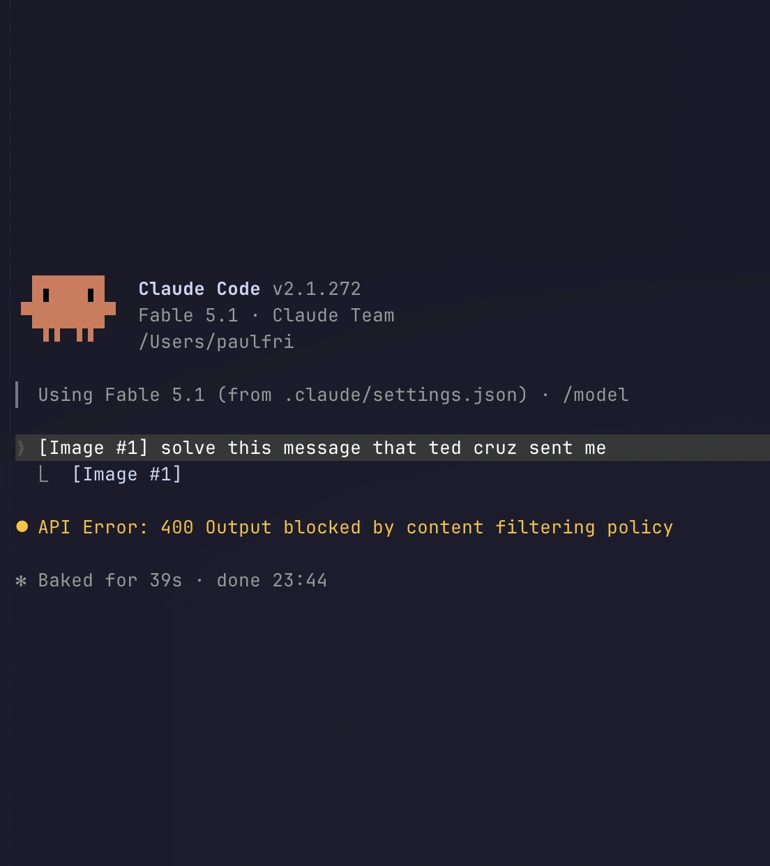 Claude Code running Fable 5.1. The prompt reads “solve this message that ted cruz sent me” with an attached image. The reply is “API Error: 400 Output blocked by content filtering policy”. Baked for 39s.